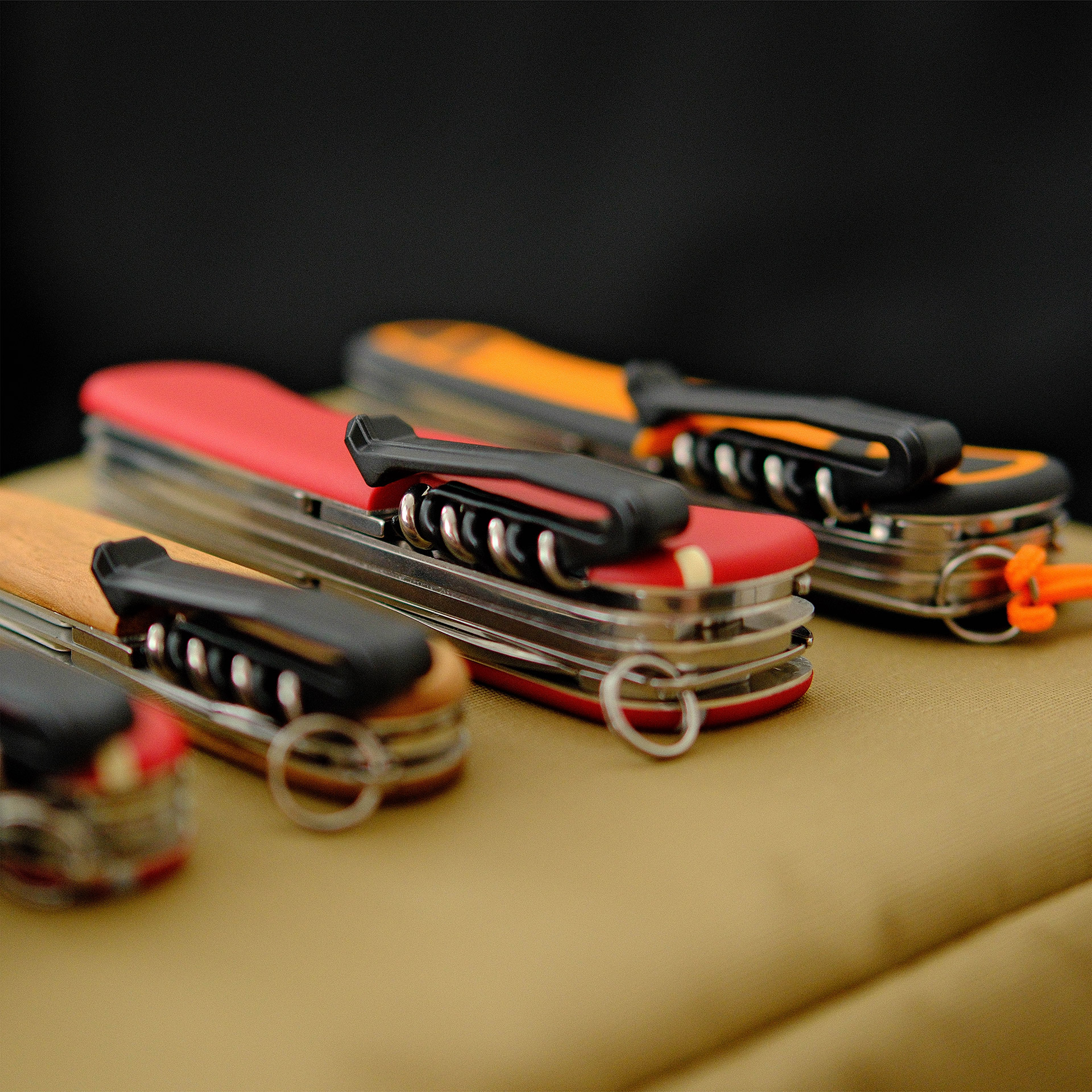 Six different Swiss Army Knives, each fitted with a Spec Wrks pocket clip